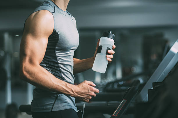 Male athlete hydrating after exercise